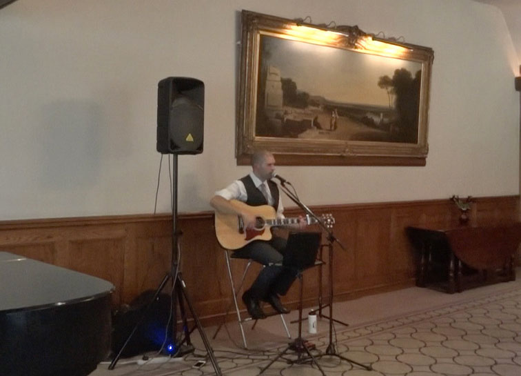 image: Castle Combe wedding ceremony guitarist